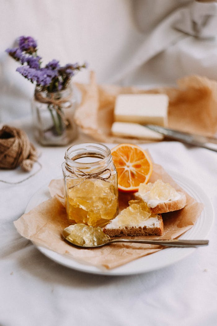 our-services-1 Delicious breakfast scene with homemade orange marmalade and rustic bread on a plate.